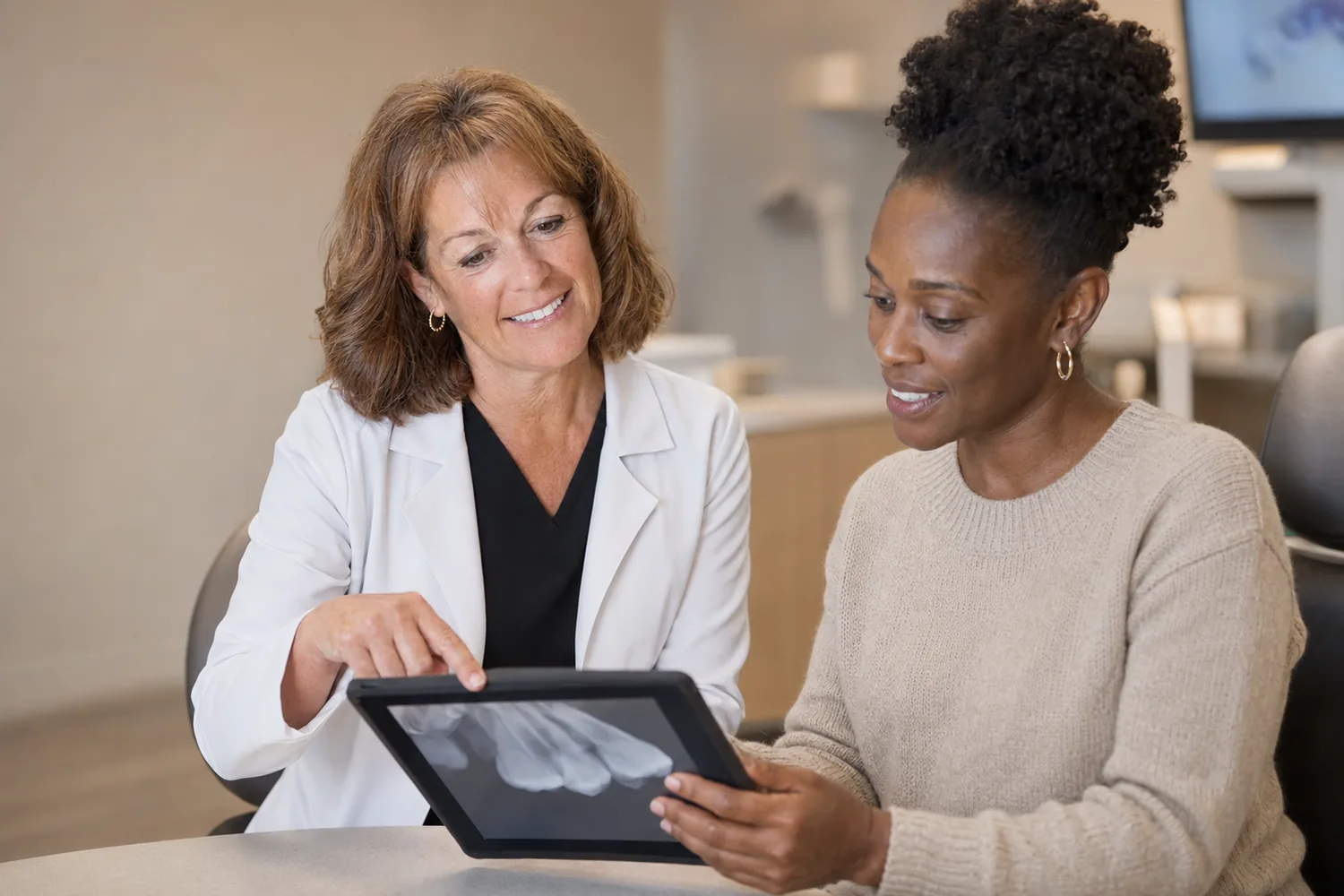 Dr. Tamara Dunlap reviewing a digital X-ray with a patient