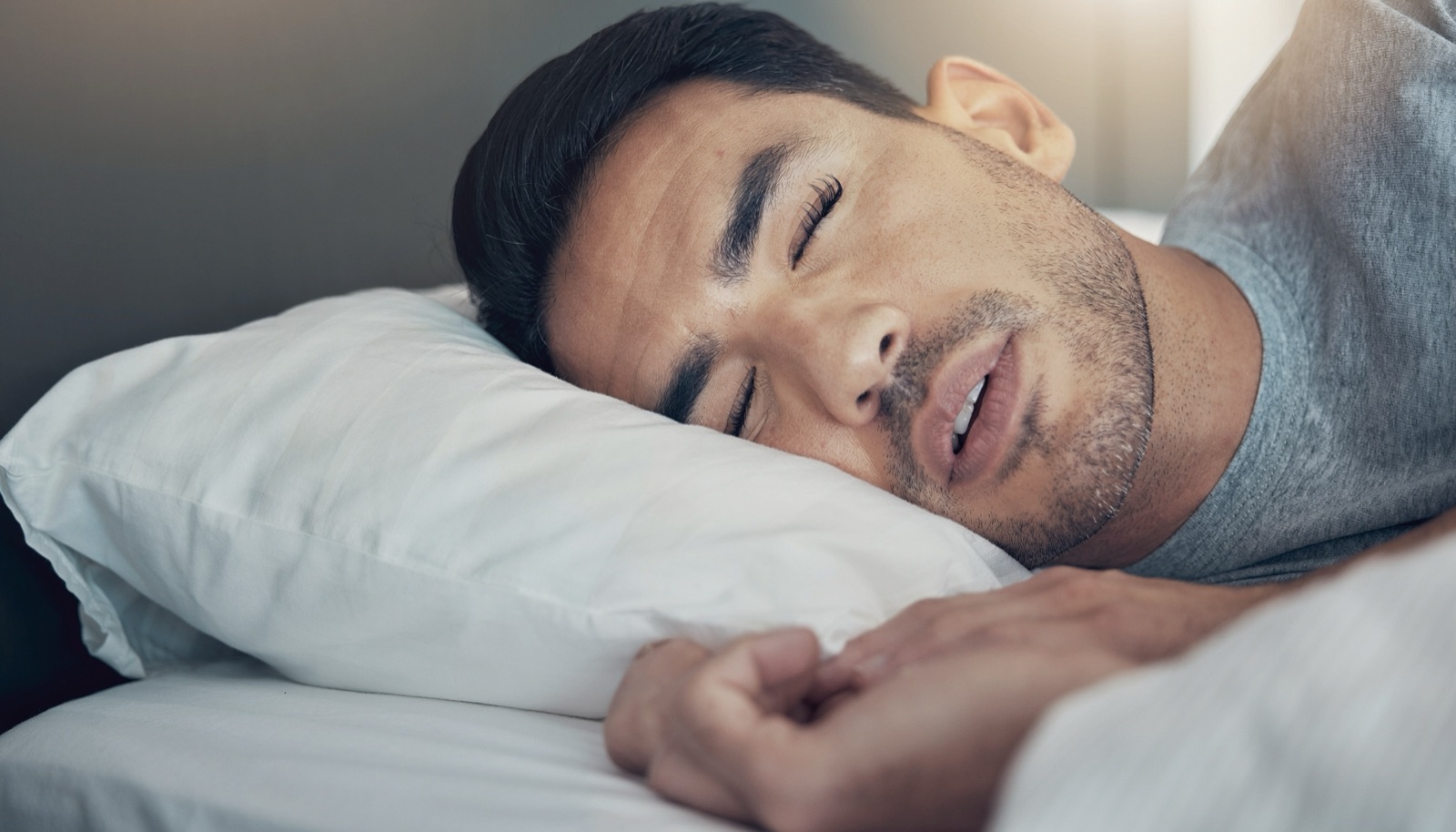 Man asleep on his pillow at night